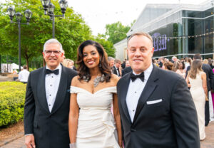 Three people at a black tie event