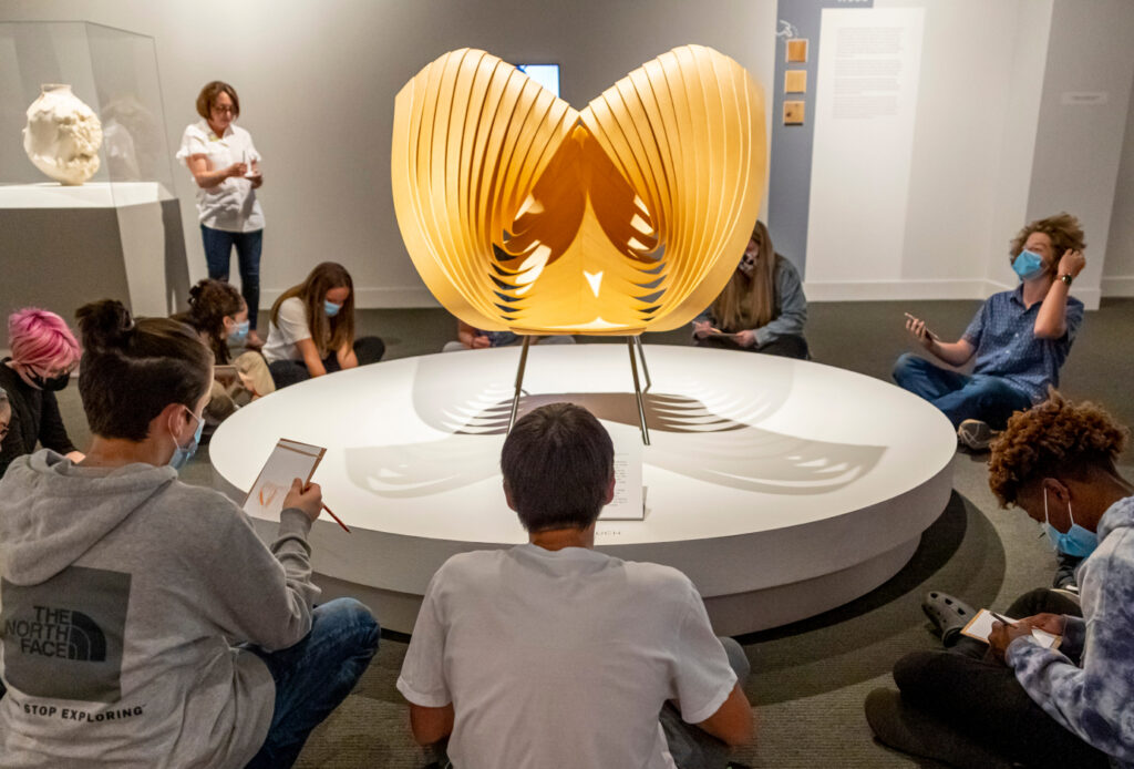 Museum guests admiring sculpture