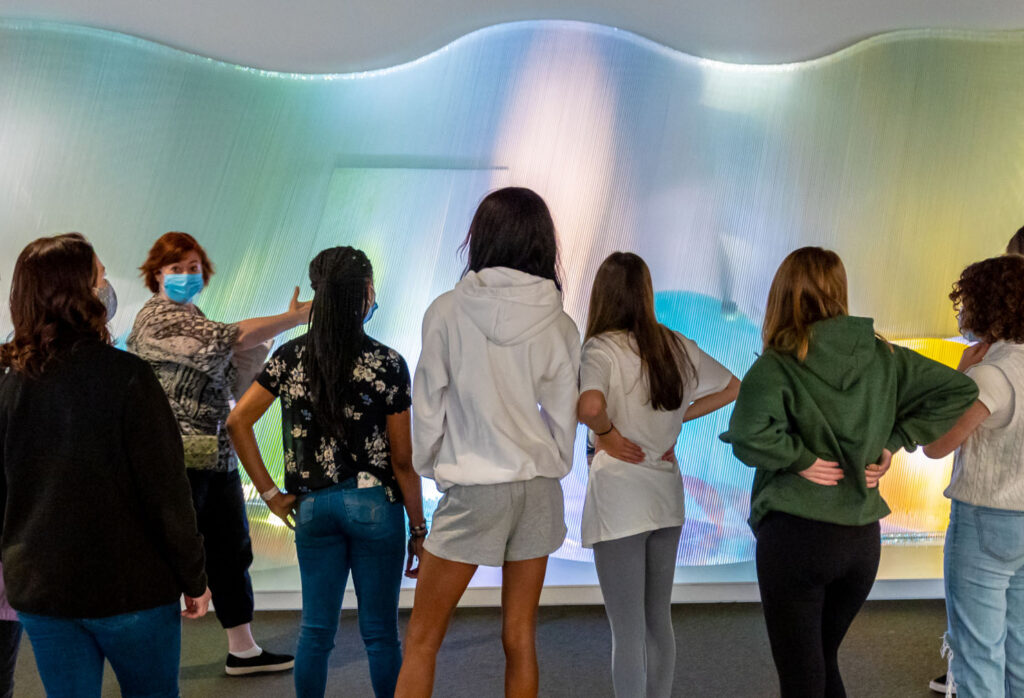 Students in front of light sculpture