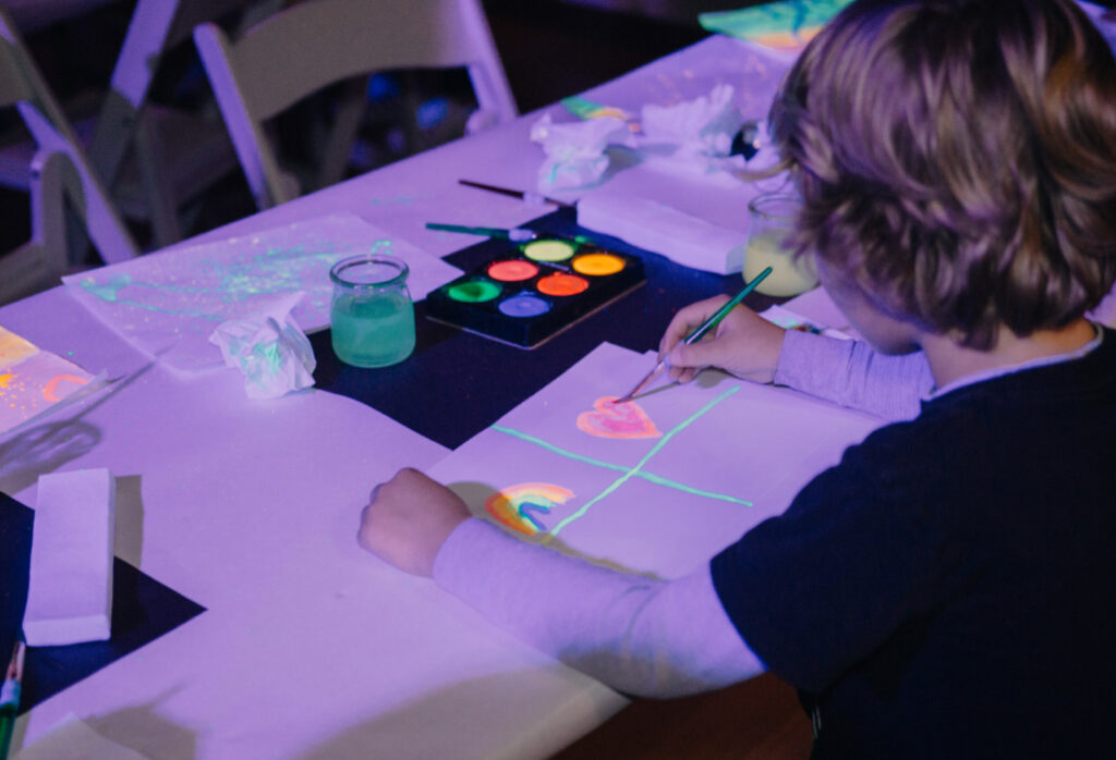 Child participating in hands-on art event
