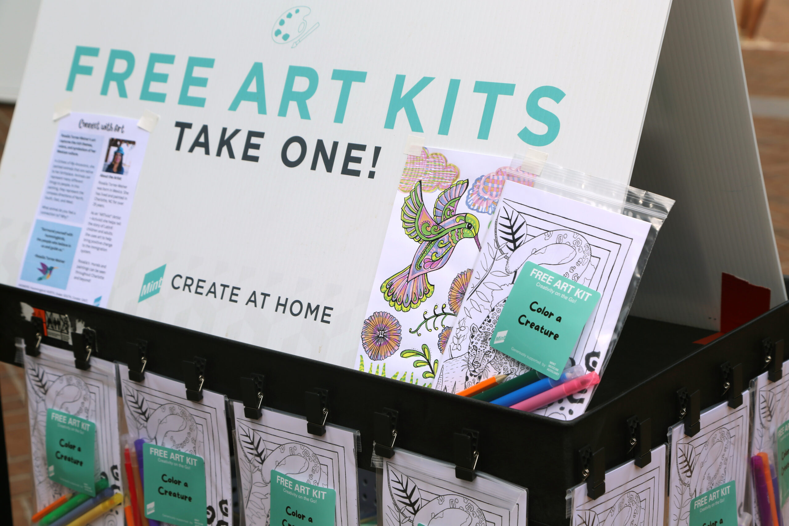 A stand with free art kits on display at the Mint Museum Randolph