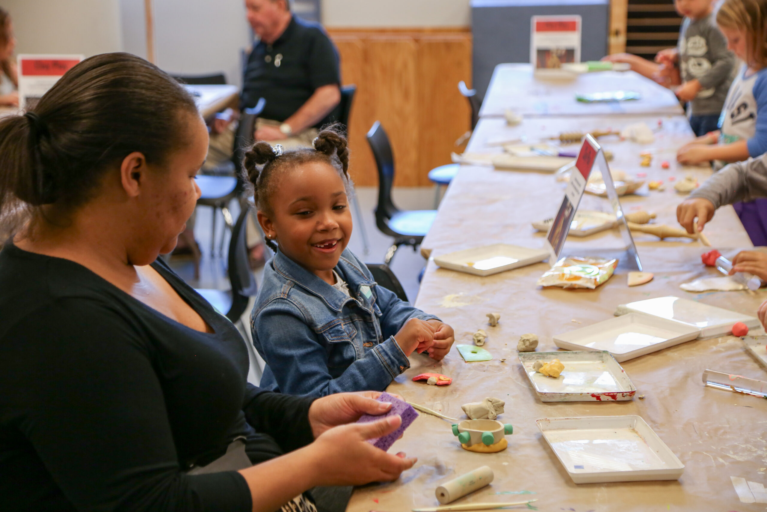 parent and child creating with clay