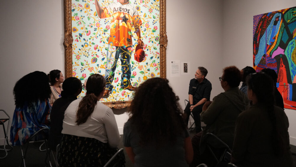 Group of educators at the Mint in front of Kehinde Wiley painting