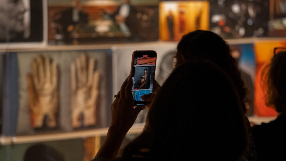 Person taking photo in Annie Leibovitz exhibition
