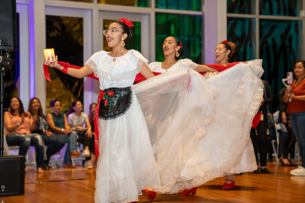 Group of young dancers with candles during Mint 2 Move Hispanic Heritage Month event