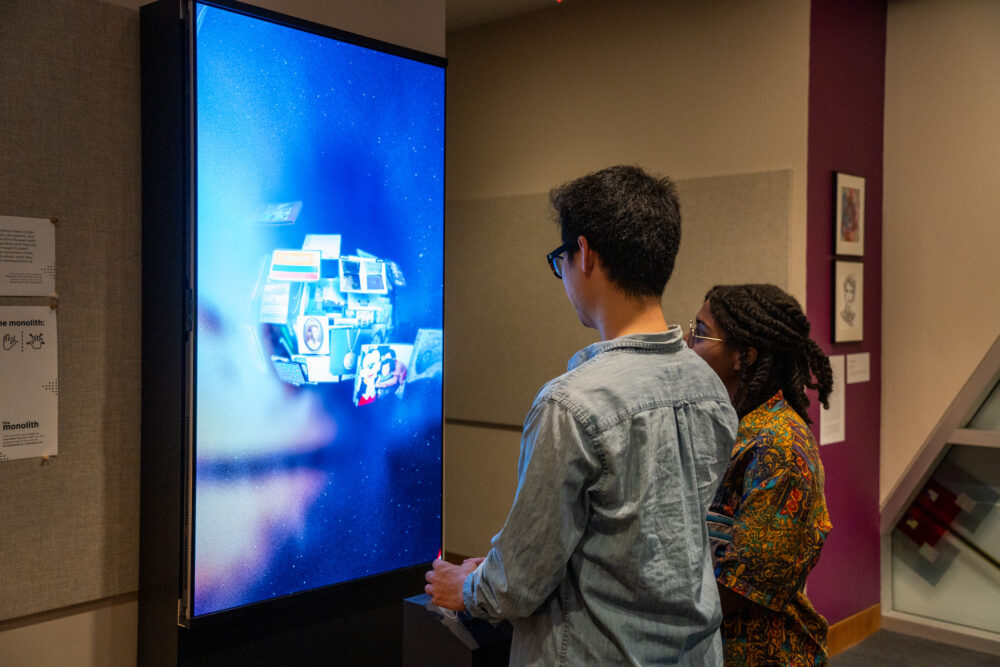 Visitors using the interactive in Staff Art Show