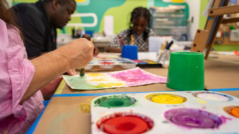 Person painting in the art room at Mint Museum Randolph.