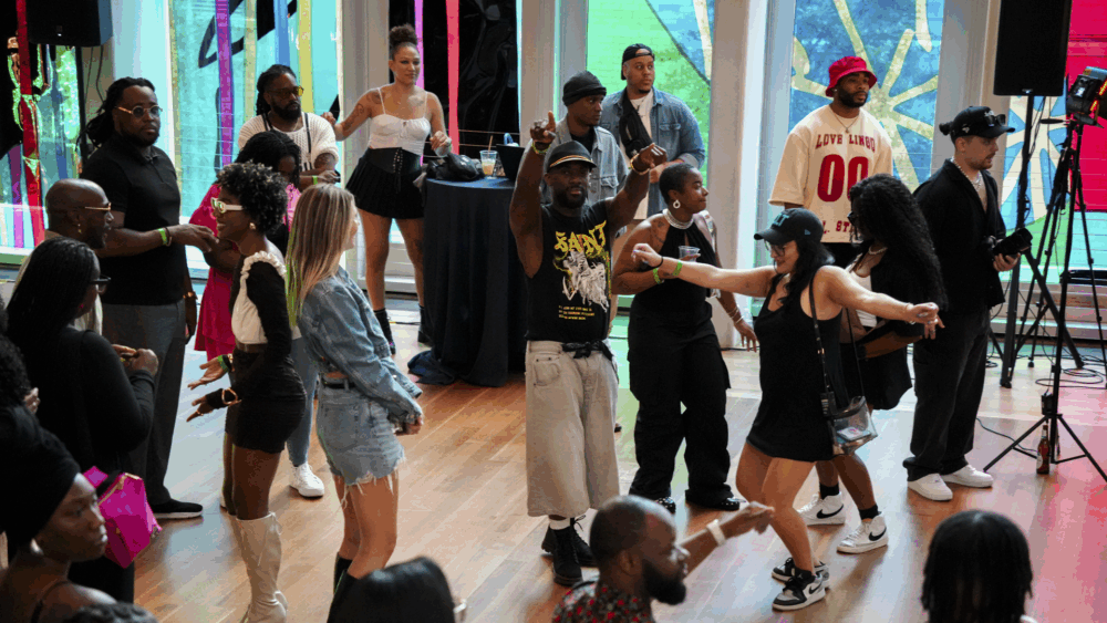Crowd of people dancing at mint museum uptown's atrium.