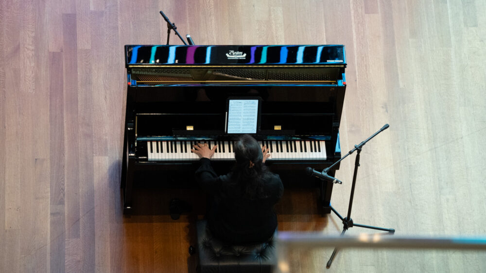 Hwa-Jin Kim performing on a Steinway piano in the museum atrium